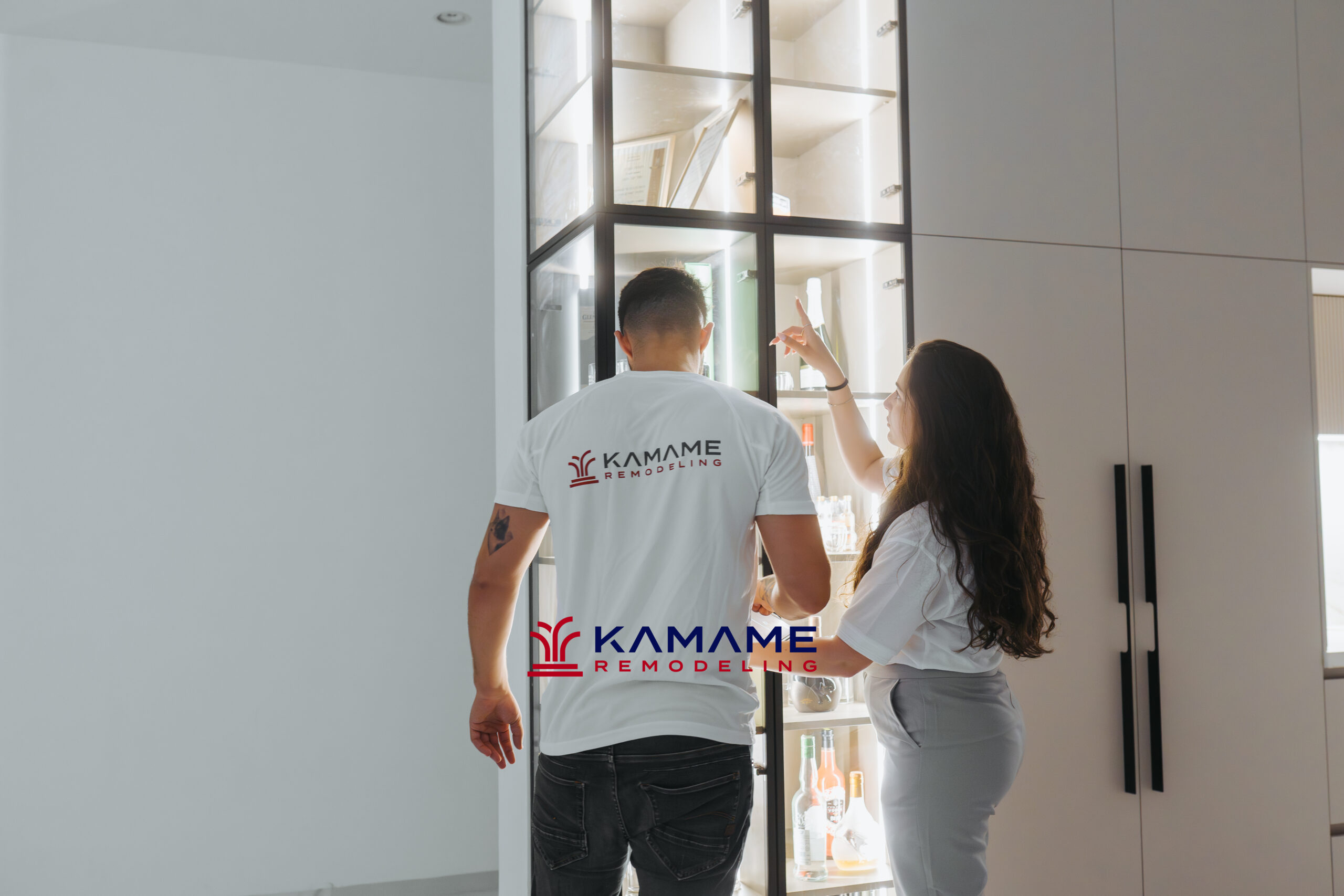 Two designers collaborating on a custom wood cabinetry design,